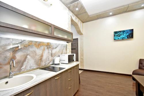 a bathroom with a sink and a microwave at Apart House in Yrevan Mashtots Avenue in Yerevan