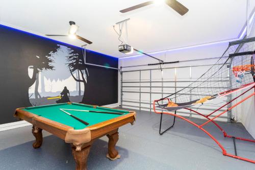 a room with a pool table and a net at Cozy 3 Bd Close to Disney @ Enclaves at Festival 808 in Davenport