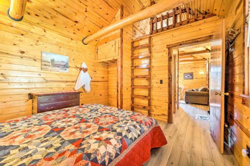 a bedroom with a bed in a wooden cabin at Clayton Cabin Rental Near Sardis Lake! in Clayton