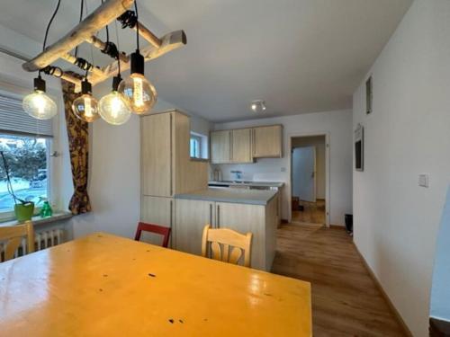 a kitchen and dining room with a wooden table at Stilvolle Familienwohnung in Wörnsmühl in Fischbachau