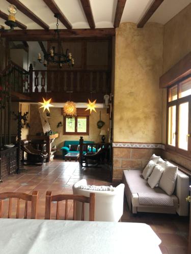 a living room with a couch and a table at Paleolítico rural 