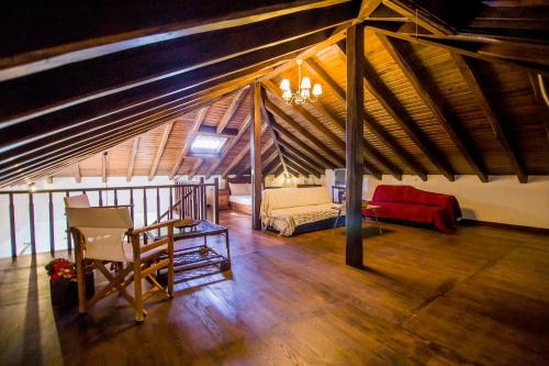 a attic room with a bed and a wooden floor at Villa Kasta in Kavála