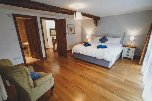 a bedroom with a bed with blue pillows on it at Hawley Farm in Hawley Bottom