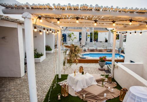 an outdoor patio with a table and a pool at Paternoster Lodge in Paternoster