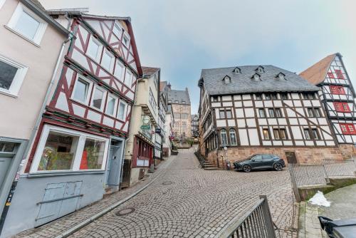 eine Gasse in einer Stadt mit Fachwerkhäusern in der Unterkunft Altstadt pur im Herzen Marburgs in Marburg an der Lahn