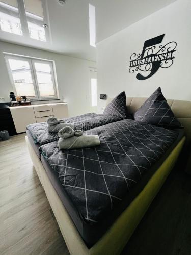 a bed with two towels on it in a room at Haus Maensel in Kelberg