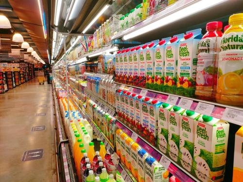 a store aisle filled with lots of bottles of milk at Legoland-Joyful Suite -2BR-8pax-Near Glen Eagle, Nice Pool city view. in Nusajaya