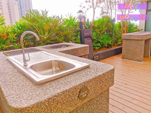 a granite counter top with a sink on a deck at Legoland-Joyful Suite -2BR-8pax-Near Glen Eagle, Nice Pool city view. in Nusajaya
