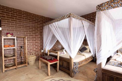 a bedroom with two bunk beds with mosquito nets at Africa Safari Karatu in Karatu