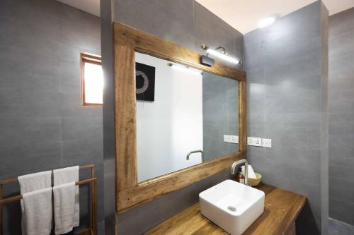 ein Badezimmer mit einem Spiegel und einem Waschbecken in der Unterkunft Africa Safari Karatu in Karatu