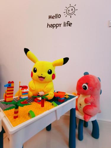 two toy pokémon sitting at a table with a play set at Legoland-Joyful Suite -2BR-8pax-Near Glen Eagle, Nice Pool city view. in Nusajaya