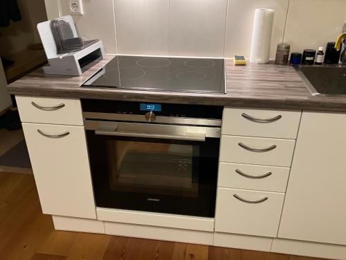 a kitchen with a stove and a counter top at Apartment.Kirche in Sankt Georgen ob Murau