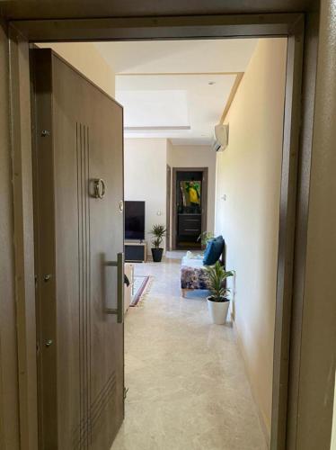 a hallway with a door open to a living room at Le Joyau Cosy Home in Mohammedia