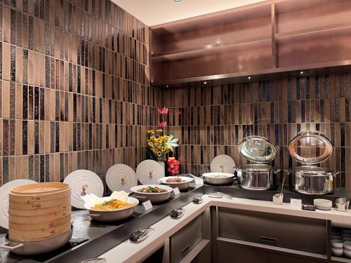 a kitchen with plates and bowls of food on a counter at Hotel Gracery Taipei in Taipei