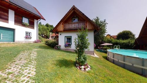 a house with a swimming pool next to a house at Winzerhaus im Schilcherland in Steinreib