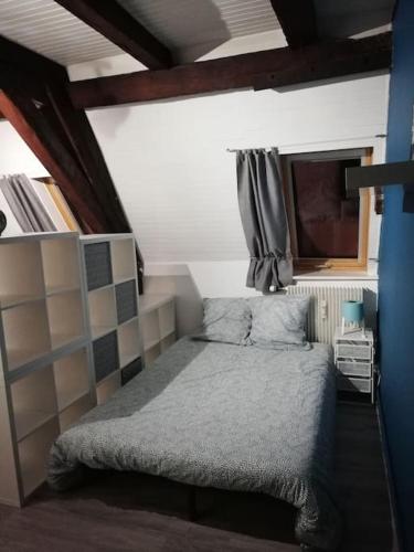 une petite chambre avec un lit et une fenêtre dans l'établissement Cité des Princes, à Montbéliard