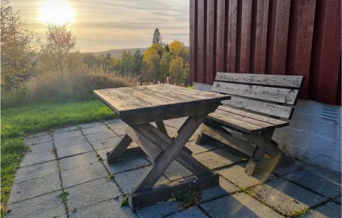 a wooden picnic table and bench on a patio at Pet Friendly Home In Evje With Wifi in Evje