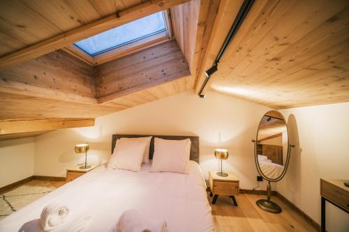 a bedroom with a bed in a room with wooden ceilings at Loft Zodiak -Centre Ville , 5 Chambres+ Vue in Les Houches