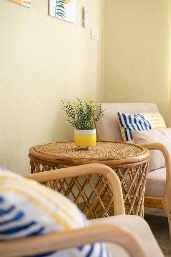 a wicker table with a potted plant on it at Indie Beach Bungalows in Ko Chang