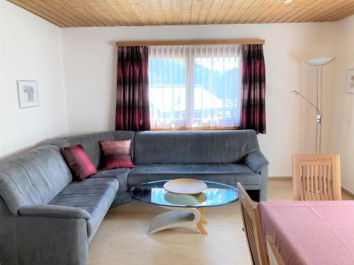 a living room with a couch and a table at Chasa Arlu in Samnaun