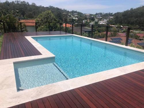 a swimming pool on top of a wooden deck at Family Fun Oasis Pool Retreat Near Theme Parks in Gold Coast
