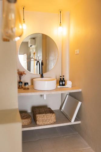 a bathroom with a sink and a mirror at Indie Beach Bungalows in Ko Chang