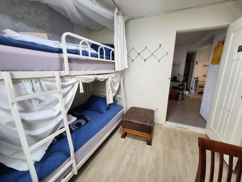 a bedroom with two bunk beds and a mirror at Aark House in Gangneung