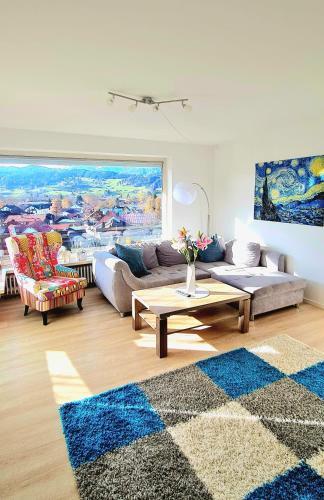 a living room with a couch and a table at Sanosueno 3 in Sonthofen