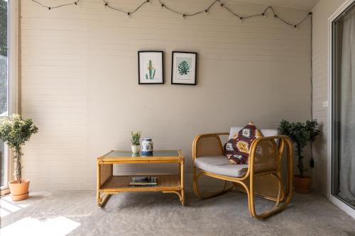 a wicker chair and a table in a room at Indie Beach Bungalows in Ko Chang