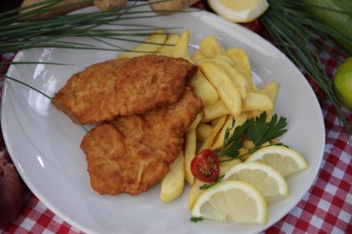 a plate of food with fish and french fries at Riverside Airport Hotel in Kelsterbach