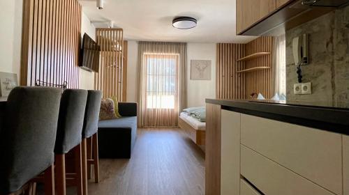 a room with a kitchen and a living room at Apartments Vaiolet in Santa Cristina Gherdëina