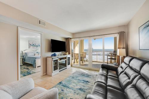 a living room with a couch and a bedroom at The Castaways in Gulf Shores