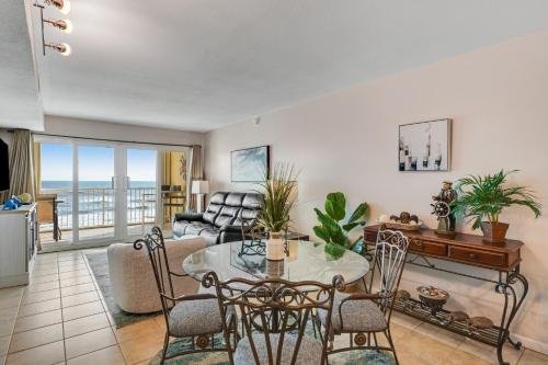 a living room with a table and chairs at The Castaways in Gulf Shores