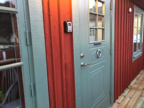 a colorful door on a building with a window at Vadstena centrum in Vadstena