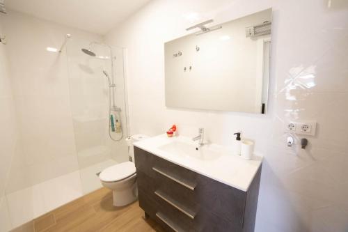 a bathroom with a sink and a toilet and a shower at ATICO CENTRO GANDIA in Gandía