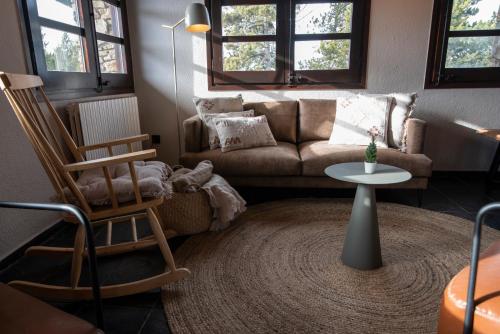 a living room with a couch and a table at Borda Conangle Mountain Lodge in Sant Julià de Lòria