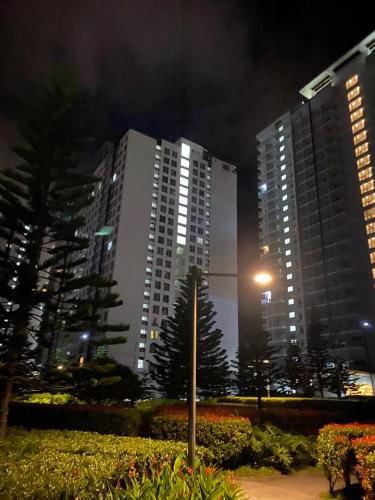 two tall buildings at night with a street light at Wind Residences in Tagaytay