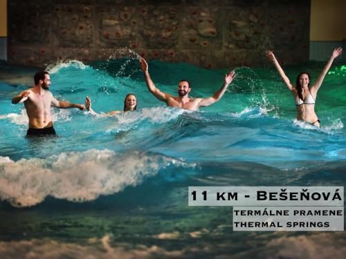a group of people in the ocean in the water at Wellness Villa Liptov in Liptovská Sielnica