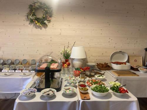 a table with several dishes of food on it at Apartamenty Black Lion in Pcim