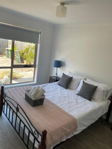 a large bed in a bedroom with a large window at Beach Haven - Beach and Cafes on your doorstep - 3 bedrooms , Sleeps 6 in Saint Leonards