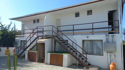 a building with a staircase on the side of it at Departamentos villamar guanaquero in Coquimbo