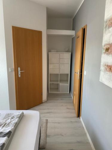 a room with a bed and a closet and a door at Blue Max Parkzimmer in Großenhain