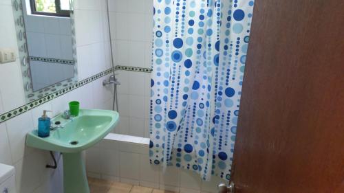 a bathroom with a sink and a shower curtain at Departamentos villamar guanaquero in Coquimbo