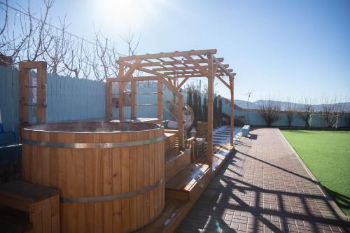 a wooden hot tub with a wooden pergola at snowflake.golan in Majdal Shams