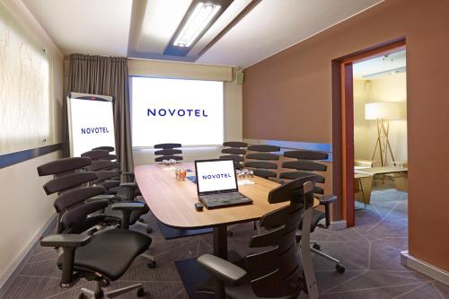 a conference room with a laptop on a table and chairs at Novotel Warszawa Centrum in Warsaw