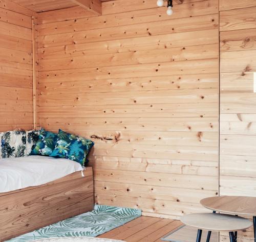 Saint-MesminにあるStudio Le Mesminoisの木製の壁のベッド1台が備わる部屋