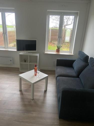 a living room with a couch and a coffee table at VV Apartments 50,1 in Ringsted