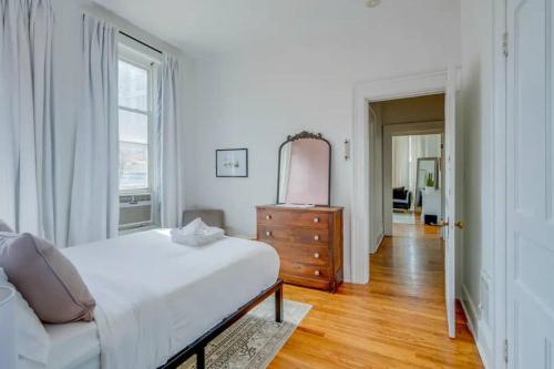a bedroom with a bed and a dresser and a mirror at Apartment on Broadway in Nashville