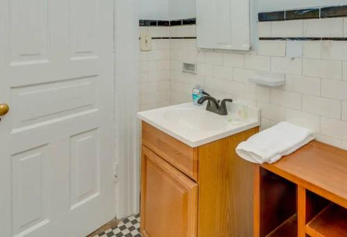 a white bathroom with a sink and a shower at Apartment on Broadway in Nashville
