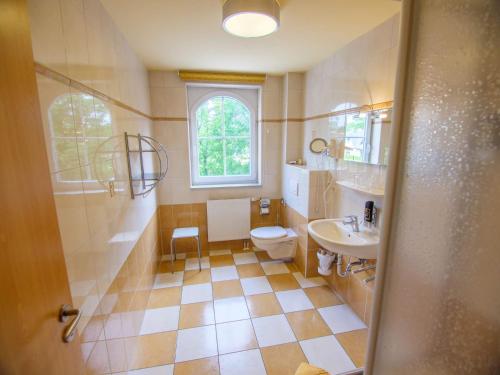 a bathroom with a toilet and a sink at Hotel Strandburg Prerow in Prerow